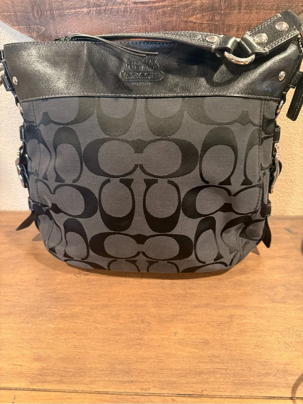 Coach Signature Logo Large Shoulder Bag in Black with large silver buckle detai